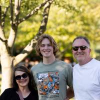 Family standing on Kirkof Lawn
